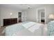 Comfortable main bedroom showcasing wood-look floors, neutral walls, and an ensuite bathroom at 14341 Passage Way, Seminole, FL 33776