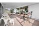 Relaxing covered patio with wicker furniture and a dining area, perfect for outdoor entertaining at 14341 Passage Way, Seminole, FL 33776