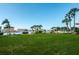 Community playground area overlooking water, with palm trees and recreational amenities at 14341 Passage Way, Seminole, FL 33776