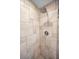 The renovated shower features decorative tiles and a modern, rainfall shower head at 14341 Passage Way, Seminole, FL 33776