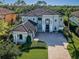 Expansive residence showcases a well-maintained lawn, intricate roofline, and stylish curb appeal from above at 14806 Harry Colt Ct, Tampa, FL 33626