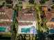 Aerial view of home featuring a backyard pool, manicured landscaping, and clay tile roof at 14806 Harry Colt Ct, Tampa, FL 33626