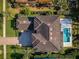 Luxury home offers a private pool and meticulously landscaped yard, captured from a bird's eye view at 14806 Harry Colt Ct, Tampa, FL 33626
