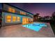 Backyard featuring a refreshing swimming pool and spa with outdoor living space, perfect for entertaining at twilight at 14806 Harry Colt Ct, Tampa, FL 33626