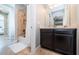 Bright bathroom featuring a granite-top vanity, shower with tile surround, and white towels at 14806 Harry Colt Ct, Tampa, FL 33626