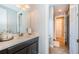 Well-lit bathroom featuring vanity with granite counter, chrome faucet, and tile floor at 14806 Harry Colt Ct, Tampa, FL 33626
