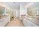 Luxurious bathroom featuring dual vanities with granite countertops and a glass-enclosed shower at 14806 Harry Colt Ct, Tampa, FL 33626