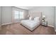 Spacious bedroom featuring a large window, neutral color palette, and tufted headboard at 14806 Harry Colt Ct, Tampa, FL 33626