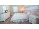 A charming bedroom featuring pastel decor, striped walls, and comfortable furnishings exudes a calming atmosphere at 14806 Harry Colt Ct, Tampa, FL 33626