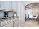 Kitchen nook area with cabinets, granite counters, coffee maker and dining area at 14806 Harry Colt Ct, Tampa, FL 33626