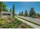 Community entrance featuring stone signage, manicured landscaping, and decorative brick street at 14806 Harry Colt Ct, Tampa, FL 33626