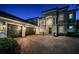 Charming two-story home exhibits manicured landscaping and a paved driveway at dusk at 14806 Harry Colt Ct, Tampa, FL 33626