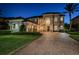 Stately two-story home boasting a meticulously landscaped front yard and a paved driveway at twilight at 14806 Harry Colt Ct, Tampa, FL 33626