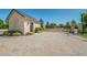 Gated community entrance featuring stone guard house, electronic gate, and brick paver street at 14806 Harry Colt Ct, Tampa, FL 33626