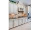 Updated kitchen features custom cabinets, granite counters, stainless steel appliances, and tiled backsplash at 14806 Harry Colt Ct, Tampa, FL 33626