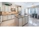 Stylish kitchen features a granite island with a breakfast bar, custom cabinets, and stainless-steel appliances at 14806 Harry Colt Ct, Tampa, FL 33626