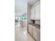 Bright kitchen area with marble floors and backsplash and white cabinetry at 14806 Harry Colt Ct, Tampa, FL 33626