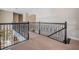 Open second story landing showcasing an ornate wrought iron railing and carpeted floor at 14806 Harry Colt Ct, Tampa, FL 33626
