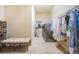Functional laundry room with a modern washer, dryer, seating and storage at 14806 Harry Colt Ct, Tampa, FL 33626