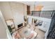 The sun-filled living room features a tall fireplace, second-story balcony, and stylish, neutral furnishings at 14806 Harry Colt Ct, Tampa, FL 33626