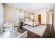 Spacious main bedroom with hardwood floors, a decorative bed, and a seating area at 14806 Harry Colt Ct, Tampa, FL 33626