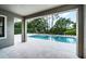 Covered patio with view of a private pool, jacuzzi and lush landscaping at 14806 Harry Colt Ct, Tampa, FL 33626