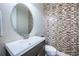Stylish powder room featuring a modern vanity and a decorative mosaic tile wall at 14806 Harry Colt Ct, Tampa, FL 33626