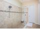 Walk-in shower featuring decorative tile, glass enclosure, and modern fixtures at 14806 Harry Colt Ct, Tampa, FL 33626