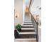 Elegant staircase featuring dark wood steps, white risers, and ornate iron railing at 14806 Harry Colt Ct, Tampa, FL 33626