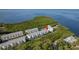 Aerial view of waterfront condos, lush greenery, and a serene coastal setting at 1500 Sunset Rd # C10, Tarpon Springs, FL 34689