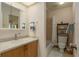 Bathroom with neutral tile flooring, wood vanity with countertop, shower and tub at 1500 Sunset Rd # C10, Tarpon Springs, FL 34689