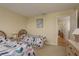 Bedroom with two twin beds, neutral colored carpeting, and a view of a doorway at 1500 Sunset Rd # C10, Tarpon Springs, FL 34689