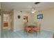 Bright dining area with a charming table set and tiled floors, perfect for intimate meals at 1500 Sunset Rd # C10, Tarpon Springs, FL 34689