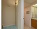 Hallway leading to the bathroom with blue tile flooring transitioning to neutral tile in the bathroom at 1500 Sunset Rd # C10, Tarpon Springs, FL 34689