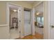Hallway between bathroom, laundry closet, and bedroom with water views at 1500 Sunset Rd # C10, Tarpon Springs, FL 34689