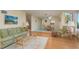 Cozy living room connected to the dining area featuring comfortable seating and relaxing ambiance at 1500 Sunset Rd # C10, Tarpon Springs, FL 34689