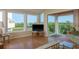 Light-filled living room featuring large windows and stylish decor, complemented by serene outdoor scenery at 1500 Sunset Rd # C10, Tarpon Springs, FL 34689