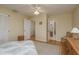 Light and airy bedroom with hardwood floors, closet, and views into bathroom and laundry areas at 1500 Sunset Rd # C10, Tarpon Springs, FL 34689
