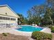 Community pool with a brick surround and lots of poolside seating at 1500 Sunset Rd # C10, Tarpon Springs, FL 34689