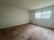 Bright bedroom with natural light, carpet, and a window overlooking the exterior at 1510 Mission Hills Blvd # 19-F, Clearwater, FL 33759
