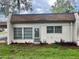 Exterior view of the property, showcasing the windows, front door, and landscaping at 1510 Mission Hills Blvd # 19-F, Clearwater, FL 33759