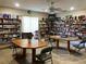 Cozy library space with floor to ceiling bookshelves, ceiling fan, and game tables at 1510 Mission Hills Blvd # 19-F, Clearwater, FL 33759