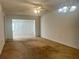 Spacious living room featuring neutral walls, ceiling fan, and adjacent sunroom for flexible living at 1510 Mission Hills Blvd # 19-F, Clearwater, FL 33759