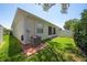 Backyard featuring lush lawn and a patio, shaded by surrounding trees at 1528 Highland Park Dr, Clearwater, FL 33756