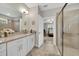 Bathroom featuring a glass shower, double sinks and a view into the bedroom at 1528 Highland Park Dr, Clearwater, FL 33756