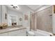 This is a bathroom with a shower-tub combo, granite counters and white cabinets at 1528 Highland Park Dr, Clearwater, FL 33756