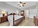 Spacious bedroom with wood floors, complemented by a ceiling fan and ample closet space at 1528 Highland Park Dr, Clearwater, FL 33756