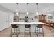 Modern kitchen features stainless appliances, a large island with seating, and dining area at 1528 Highland Park Dr, Clearwater, FL 33756