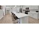 Modern kitchen features stainless appliances, a large island with seating, and white cabinets at 1528 Highland Park Dr, Clearwater, FL 33756
