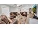 Spacious living room featuring comfortable seating, an open floor plan, and wood floors at 1528 Highland Park Dr, Clearwater, FL 33756